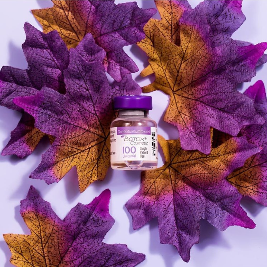 BOTOX bottle surrounded by colorful leaves