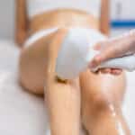 young slender woman get hair removal procedure on legs. beauty cosmetic procedures in salon. beautiful woman has prefect smooth and soft skin on legs