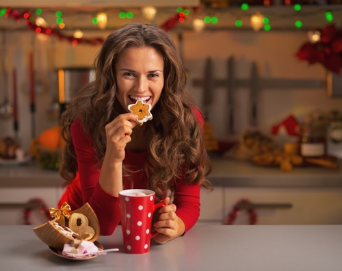 Happy,Young,Woman,Having,Eating,Christmas,Cookies,In,Kitchen