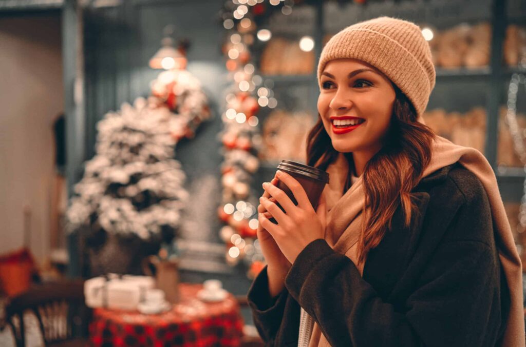 Woman outside during the holidays, smiling with radiant skin from laser treatments