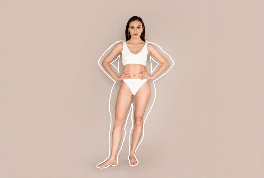 Fit, slim woman revealing her post-CoolSculpting Elite figure, with an outline of her former, larger shape around her